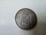a close up of a coin on a table with a white background