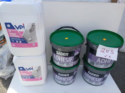 three buckets of adhesive and a bottle of adhesive on a table