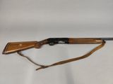 the rifle is laying on a white surface and ready to be used
