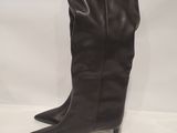 a close up of a pair of black boots on a white surface