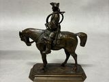 bronze statue of a man on a horse with a hat on his head