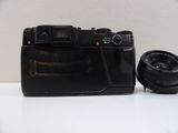 a black camera sitting on a table next to a lens
