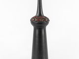 an image of a black vase sitting on top of a white table