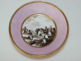 a plate with a picture of a farm on it