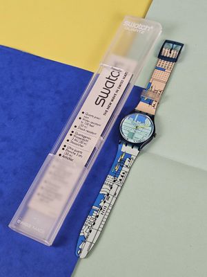 a watch and a pen sitting next to each other on a piece of paper