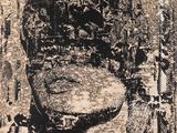 black and white photograph of a man ' s head in a stone slab