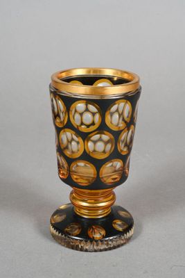 a black and gold vase with a flower design on it
