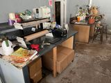 a cluttered kitchen with a lot of clutter on the counter