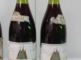 three bottles of wine sitting on a table next to each other