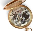 a gold pocket watch with a chain attached to it