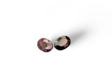 a pair of pink tourmaline gems on a white background