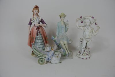 three figurines of people standing next to each other