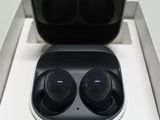 an image of a pair of black earphones sitting on top of a white box