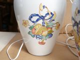 a white vase with a blue ribbon on it