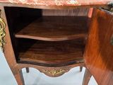 a small wooden cabinet with a marble top