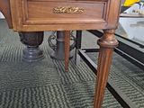 a desk with a drawer on top of it in a room