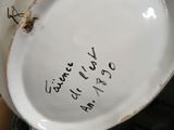 a close up of a white plate with writing on it