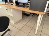 a desk with a computer monitor and a keyboard on it