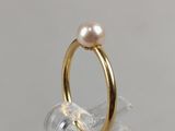 gold plated ring with a single pearl in the middle