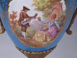 a blue vase with a picture of a man and a woman on it