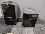 two speakers sitting next to each other on the floor