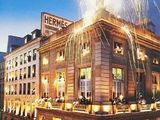 a large building with a firework display on top of it