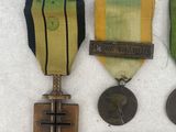 several medals and medals are displayed on a white surface