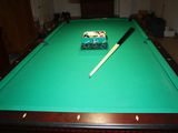 a pool table with a pool cue on top of it