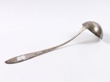 a spoon with a handle on a white surface