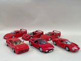 six red cars lined up in a row on a white surface