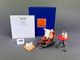 a small figurine of a cat sitting on a rocking chair