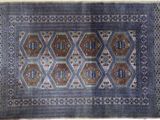 an old rug with a blue and brown design on it