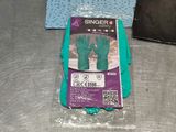 a package of gloves on a table next to a pair of gloves