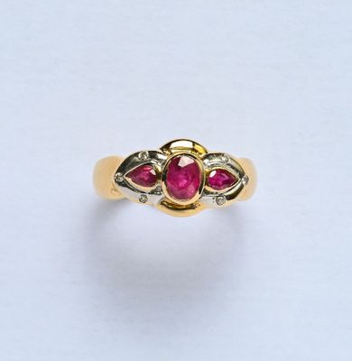Bague en or 18K (750/oo) de 2 tons, centrée d'un rubis ovale…