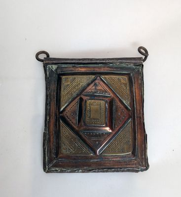 an image of a metal plaque with a square design on it