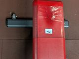 a red bench sitting on a tiled floor next to a wall