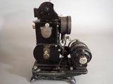 an old fashioned sewing machine sitting on a white surface