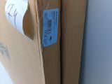a cardboard box with a sticker on it sitting on the floor