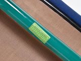 a green sticker on the handle of a green bike