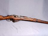 un vieux fusil en bois sur fond blanc, avec un chapeau vert