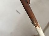 a close up of a metal chair with a rusted seat