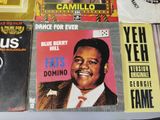 a lot of records that are on a table
