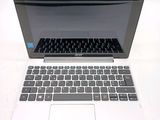 a white laptop with a black keyboard sitting on a table