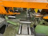 an image of a machine that is working on a piece of metal
