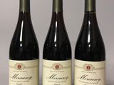three bottles of wine sitting on top of a table next to each other