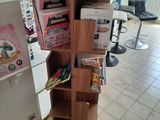 a tall wooden book shelf with a lot of books on it