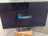 a flat screen tv sitting on top of a cardboard box