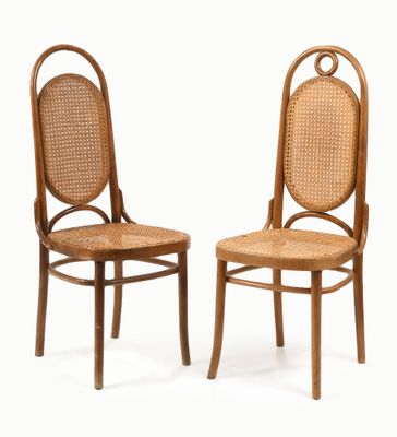 two wooden chairs with wicker seats on a white background