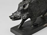 statue of a boar on a marble base on a white background