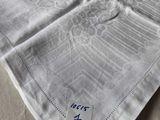 a white towel with blue writing on it on a bed